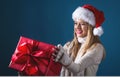 Young woman with santa hat holding a gift box Royalty Free Stock Photo