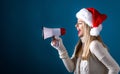 Young woman with santa hat holding a megaphone Royalty Free Stock Photo