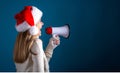 Young woman with santa hat holding a megaphone Royalty Free Stock Photo