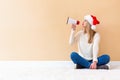 Young woman with santa hat holding a megaphone Royalty Free Stock Photo