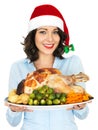 Young Woman in Santa Hat Holding Roast Turkey and Vegetables Royalty Free Stock Photo