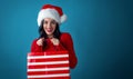 Young woman with santa hat holding a shopping bag Royalty Free Stock Photo