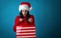 Young woman with santa hat holding a shopping bag Royalty Free Stock Photo