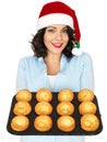 Young Woman in Santa Hat Holding a Tray of Yorkshire Puddings