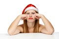 Young woman in santa hat with scowl look