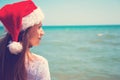 Young woman in santa hat on tropical beach. Christmas vacation. Christmas beach vacation travel woman wearing Santa hat and bikini Royalty Free Stock Photo