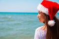 Young woman in santa hat on tropical beach. Christmas vacation. Christmas beach vacation travel woman wearing Santa hat and bikini Royalty Free Stock Photo