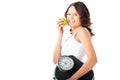 Young woman with scale under her arm and apple Royalty Free Stock Photo