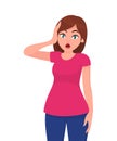 Young woman shocked/scared face expression with her hands on the head. Human emotion and body language concept illustration. Royalty Free Stock Photo