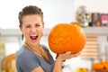 Young woman scaring with big Halloween pumpkin Jack-O-Lantern Royalty Free Stock Photo