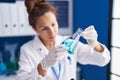 Young woman scientist measuring liquid working at laboratory Royalty Free Stock Photo