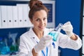 Young woman scientist measuring liquid working at laboratory Royalty Free Stock Photo