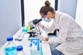 Young woman scientist using microscope working at laboratory Royalty Free Stock Photo