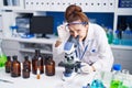 Young woman scientist using microscope working at laboratory Royalty Free Stock Photo