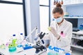 Young woman scientist using microscope working at laboratory Royalty Free Stock Photo