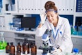 Young woman scientist using microscope working at laboratory Royalty Free Stock Photo