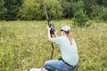 Young woman scientist zoologist sets camera trap for observing wild animals in forest to collect scientific data Environmental