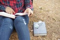 Young woman scottish shirt reading a book