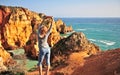 Young woman at sea cliffs, Lagos, Portugal Royalty Free Stock Photo