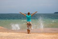 Young woman and sea wave. Sunny tropical coast view with relaxed woman.