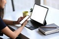 Young woman searching information on tablet computer and using mobile phone contact business.. Royalty Free Stock Photo