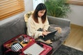 Young woman searching information weekend vacation trip on digital tablet. Travel and vacation concept Royalty Free Stock Photo