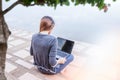 Young woman searching for jobs with a laptop.