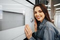 Young woman selected a new microwave oven in hypermarket Royalty Free Stock Photo