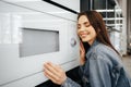 Young woman selected a new microwave oven in hypermarket Royalty Free Stock Photo