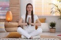 Young woman during self-healing session in room Royalty Free Stock Photo