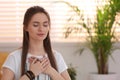 Young woman during self-healing session in room Royalty Free Stock Photo