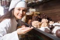 Young woman selling fine chocolates and confectionery in cafe Royalty Free Stock Photo