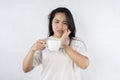 Young woman with sensitive teeth and cup of hot coffee at home