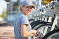 Young woman servicing rental public city bikes Royalty Free Stock Photo