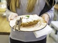 Woman serving apple pie on the white plate for breakfast