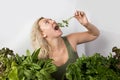 Young woman with a set of green Ingredients lettuce, spinach for a healthy diet