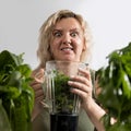 Young woman with a set of green Ingredients lettuce, spinach for a healthy diet