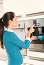 Young woman setting coffee maker machine kitchen Royalty Free Stock Photo