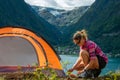 Traveling Norway, Young woman sets up tent, Beautiful view of Buerdalen Valley and Sandvevatnet Lake near city of Odda Norway Royalty Free Stock Photo