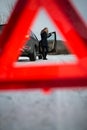 Young woman setting up a warning triangle and calling for assistence Royalty Free Stock Photo