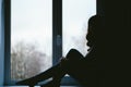 Young woman sexually sits on a window sill closeup