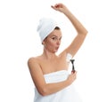 Young woman shaving armpit. Hair removal and skin care concept.