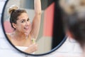 Young woman shaving armpits in bathroom Royalty Free Stock Photo