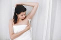 Young woman shaving armpits with plastic razor closeup in home bathroom. Skin care. Hair Removal concept. Copy space. Hand holding Royalty Free Stock Photo