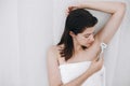 Young woman shaving armpits with plastic razor closeup in home bathroom. Skin care. Hair Removal concept. Copy space. Hand holding Royalty Free Stock Photo