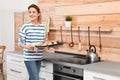 Young woman with sheet pan of oven baked cookies Royalty Free Stock Photo