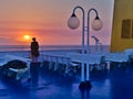 Young woman on ship looking at the sunset