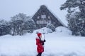 Young woman in Shirakawa-go village in winter, UNESCO world heritage sites, Japan Royalty Free Stock Photo