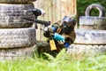 Young woman shooting from paintball gun