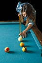 Young woman shooting pool Royalty Free Stock Photo